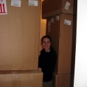 Jenny hids amongst the boxes