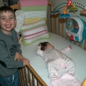 Cousin Max with Sara in her crib