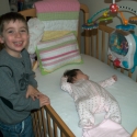 Cousin Max with Sara in her crib