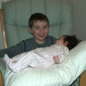 Max rocks cousin Sara in her glider chair
