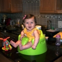 Sitting in her new bumbo seat, watching daddy cook!