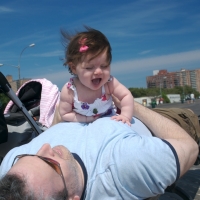 Sara and Daddy playing on the boardwalk in Coney Island