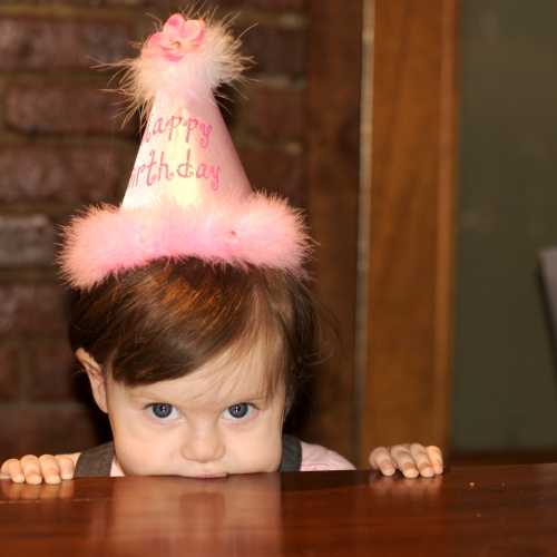 The birthday girl awaits her cake!