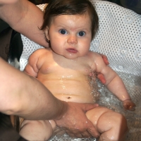 Now too big for her bathtub, Sara enjoys getting clean right in the sink