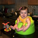 Sitting in her new bumbo seat, watching daddy cook!