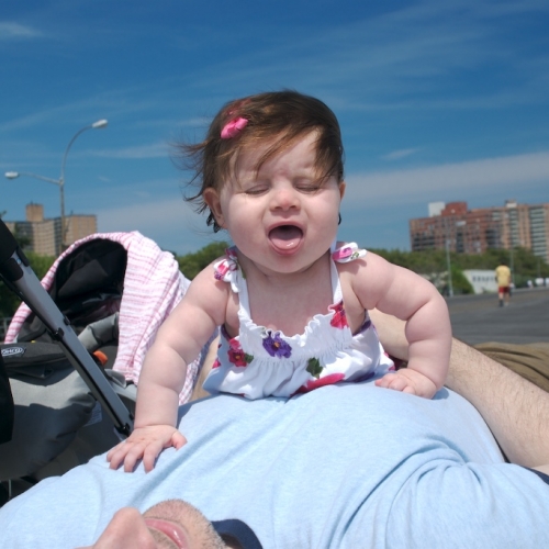 Sara and Daddy playing on the boardwalk in Coney Island