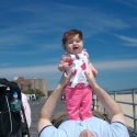Sara and Daddy playing on the boardwalk in Coney Island