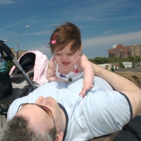 Sara and Daddy playing on the boardwalk in Coney Island
